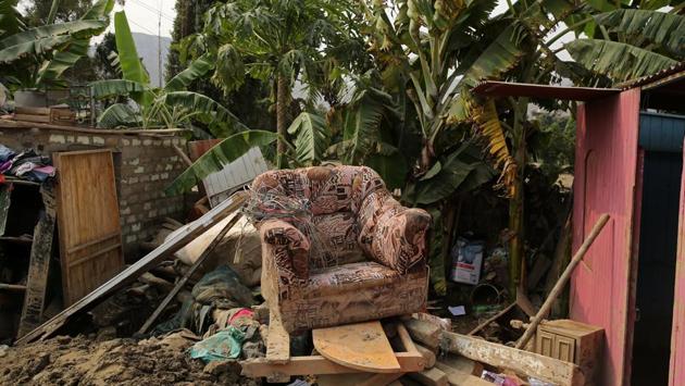 A chair sits on top of belongings after rivers breached their banks due to torrential rains, causing flooding and widespread destruction in Carapongo Huachipa, Lima, Peru. (Mariana Bazo/REUTERS)