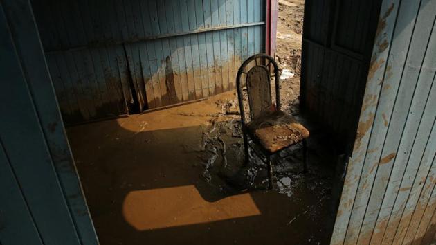 A chair stands in mud at the home of Francisco Coca. (Mariana Bazo/REUTERS)