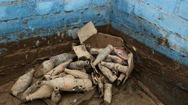 Bottles lie in mud. Many of the hardest hit are those who can least afford it - poor Peruvians who built their homes on cheap land near the river. (Mariana Bazo/REUTERS)