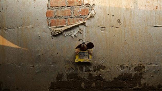 A picture hangs on the wall at the home of Paulino Rojas. (Mariana Bazo/REUTERS)