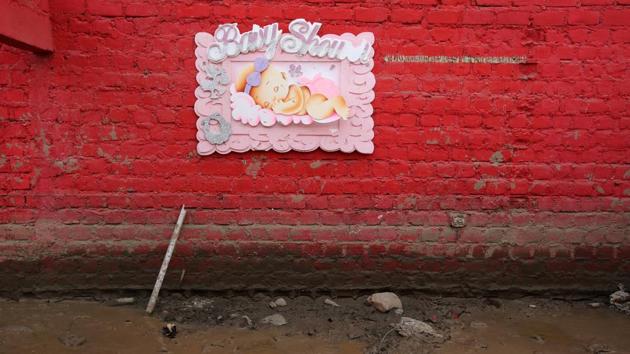 A baby shower sign hands on a wall at the home of Carlos Rojas. (Mariana Bazo/REUTERS)