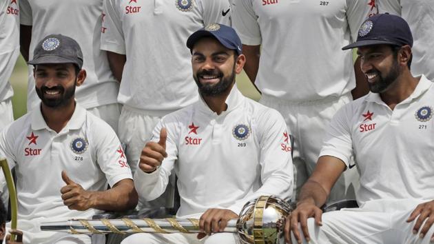 India's captain Virat Kohli gestures as the team poses with the Border-Gavaskar Trophy and the Test mace after winning the fou-match Test series against Australia in Dharmsala on Tuesday.(AP)