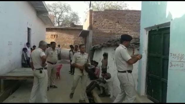 Police at the house of Niranjan Ahriwar in Dharampura village, where the incident took place.(HT Photo)