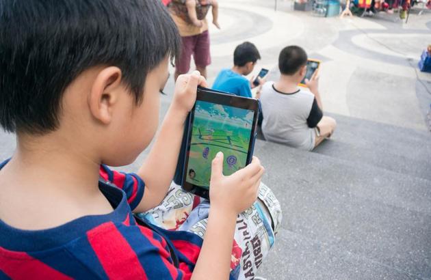 Parents say they talk to their kids more than usual when they play Pokemon GO with them, both about the game and other things in their lives.(Shutterstock)