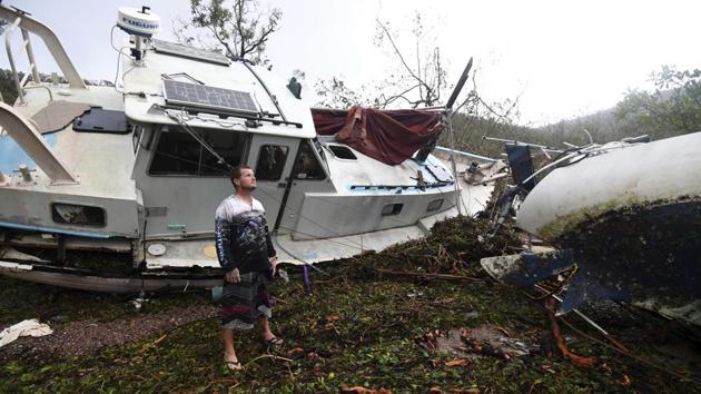 Bradley Mitchell inspects the damage to his uncle's boat after it smashed against the bank at Shute Harbour, Airlie Beach, Australia. Cyclone Debbie, which slammed into the coast of Queensland state on Tuesday with winds up to 260 kilometers (160 miles) an hour, weakened quickly as it moved inland and was downgraded to a tropical low. (Dan Peled/AAP Image via AP) Bradley Mitchell inspects the damage to his uncle's boat after it smashed against the bank at Shute Harbour, Airlie Beach, Australia. Cyclone Debbie, which slammed into the coast of Queensland state on Tuesday with winds up to 260 kilometers (160 miles) an hour, weakened quickly as it moved inland and was downgraded to a tropical low. (Dan Peled/AAP Image via AP)