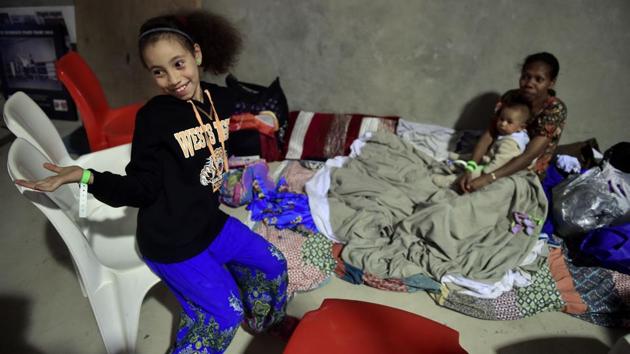 A family relax in a temporary cyclone shelter in the town of Ayr in far north Queensland as Cyclone Debbie approaches. (Peter Parks/AFP) A family relax in a temporary cyclone shelter in the town of Ayr in far north Queensland as Cyclone Debbie approaches. (Peter Parks/AFP)