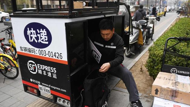 From making illegal cross-border deliveries to China in a minivan to buying a fleet of Boeing aircraft, the boss of SF Express has ridden a wave of online shopping to become one of the country's richest men.(AFP Photo) From making illegal cross-border deliveries to China in a minivan to buying a fleet of Boeing aircraft, the boss of SF Express has ridden a wave of online shopping to become one of the country's richest men.(AFP Photo)