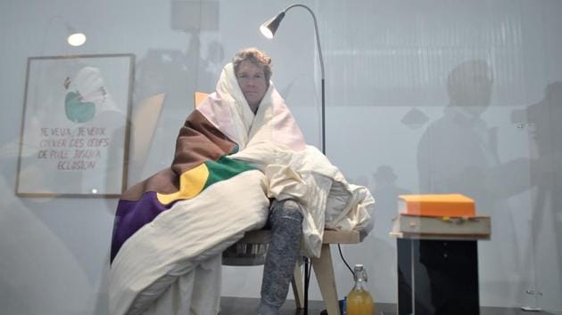 French artist Abraham Poincheval sits on real chicken eggs until they hatch during a performance at the Palais de Tokyo on Wednesday in Paris.(AFP Photo)