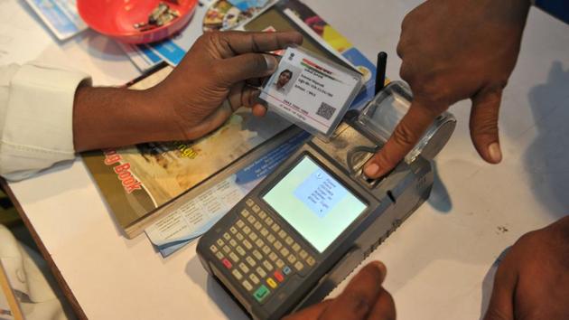An Indian visitor gives a thumb impression to withdraw money from his bank account with his Aadhaar or Unique Identification (UID) card during a Digi Dhan Mela, held to promote digital payment, in Hyderabad on January 18.(AFP File Photo) An Indian visitor gives a thumb impression to withdraw money from his bank account with his Aadhaar or Unique Identification (UID) card during a Digi Dhan Mela, held to promote digital payment, in Hyderabad on January 18.(AFP File Photo)