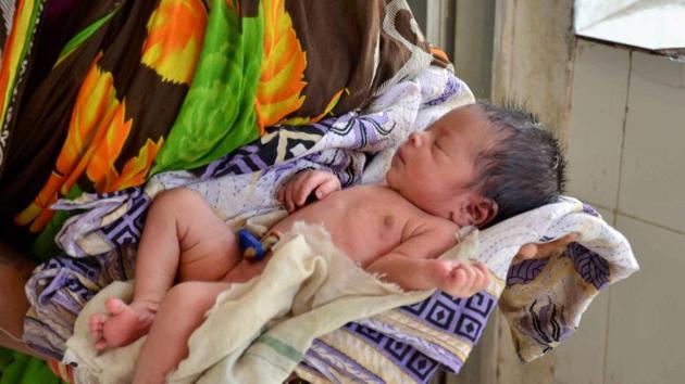 An ASHA worker holds the newborn baby girl, who was found buried alive in a manure heap at Shyamsundarpur village in Odisha. (PTI Photo) An ASHA worker holds the newborn baby girl, who was found buried alive in a manure heap at Shyamsundarpur village in Odisha. (PTI Photo)