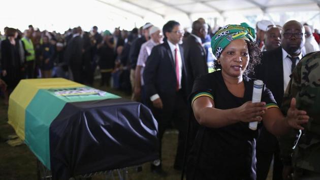 A mourner gestures next to a casket of Ahmed Kathrada. The court made the finding after Zuma had refused to abide by an order to pay back some of the millions of dollars in public money spent on upgrading his rural home. (Siphiwe Sibeko/REUTERS) 