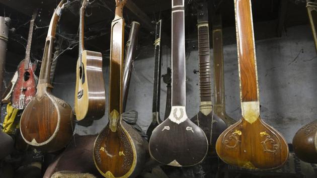 Different musical instruments hang from the ceiling at Hemen & Co. The world of digitization and popularity of Bangla rock bands have changed the way their business used to be. (Samir Jana/HT PHOTO)