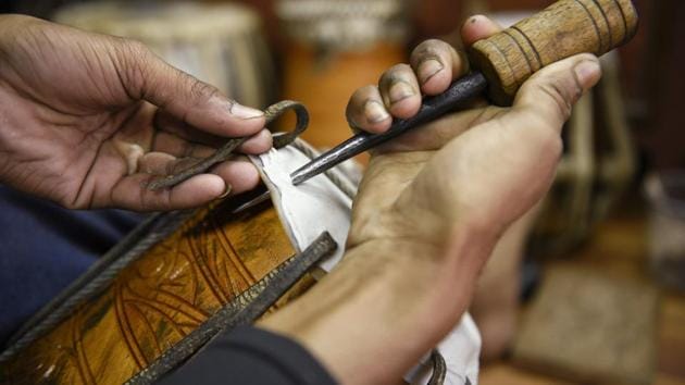 An employee of Rhythm, a famous shop & workshop, works on a tabla. Owned by 42-year-old Mukta Das, his shop produces nearly 1500 instruments in a year. (Samir Jana/HT PHOTO)