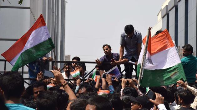 Indian employees of mobile phone company Oppo protest outside their office in Noida’s Sector 63 after a Chinese national allegedly threw India’s national flag in a dustbin.(HT Photo)