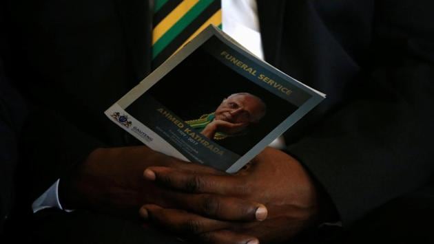 A mourner holds a programme bearing the face of Ahmed Kathrada. Anti-apartheid leader Ahmed, who spent 26 years in prison for opposing South Africa’s white minority government - much of that time alongside the country’s first black president, Nelson Mandela - died Tuesday at age 87. (Siphiwe Sibeko/REUTERS) 