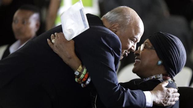Pravin Gordhan, South Africa's finance minister, left, greets former President Nelson Mandela's wife, Winnie Madikizela-Mandela, during the funeral service for Ahmed Kathrada, at West Park Cemetery in Johannesburg. Zuma, meanwhile, described Kathrada as a much-loved member of South Africa’s long liberation struggle and ordered the national flag to be flown at half-mast at all government buildings. (Themba Hadebe/AP) 