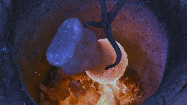A Dokra craft figurine made of bronze undergoes treatment in a smelter. (Arabinda mahapatra/ht photo) A Dokra craft figurine made of bronze undergoes treatment in a smelter. (Arabinda mahapatra/ht photo)