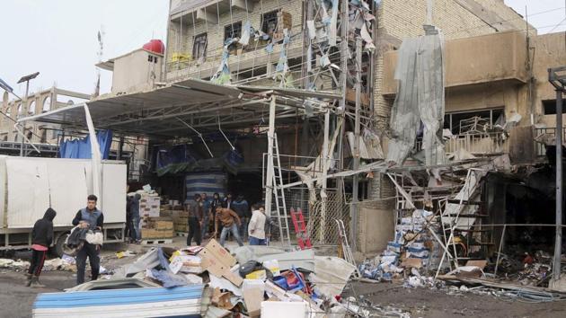 People inspect the aftermath of a suicide car bombing in a commercial area in Baghdad's southwestern Amil neighborhood. (AP File Photo) People inspect the aftermath of a suicide car bombing in a commercial area in Baghdad's southwestern Amil neighborhood. (AP File Photo)