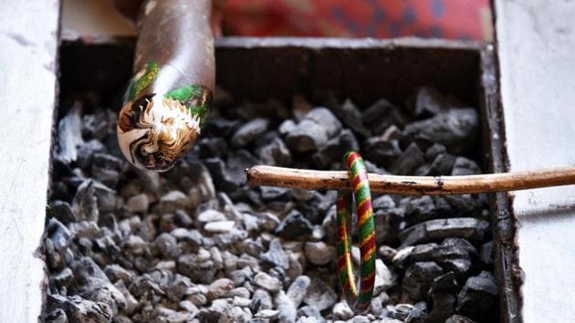 An artist processing a Lacquer craft bangle on the burning coal commonly used by the Bathudi tribe women . (Arabinda Mahapatra/Ht Photo) An artist processing a Lacquer craft bangle on the burning coal commonly used by the Bathudi tribe women . (Arabinda Mahapatra/Ht Photo)