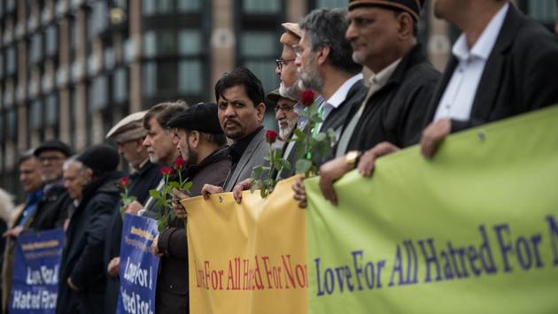 Among them were dozens of young Muslims from the Ahmadiyya community, several holding banners that read: “Love for all, hatred for none.”They stood alongside senior police officers, Muslim and Jewish faith leaders, schoolchildren, tourists, workers from nearby offices and passersby, who had begun gathering hours earlier to pay their respects.  (Oli Scarff/AFP) 