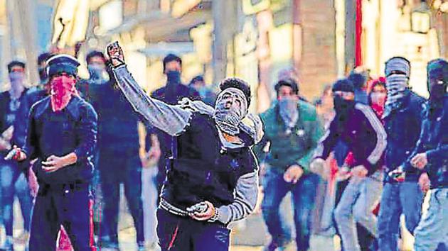 Kashmiri youth throw stones at security forces during protests in Srinagar. Government data shows 2016 saw 88 civilians joining militancy in the valley after the killing of Hijbul Mujahideen commander Burhan Wani.(AP file photo)