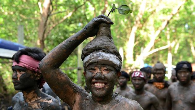A Balinese boy puts mud on his body during a mud bath tradition . (Sonny Tumbelaka / AFP) A Balinese boy puts mud on his body during a mud bath tradition . (Sonny Tumbelaka / AFP)