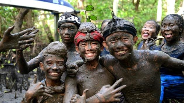 Children pose for a picture during the mud bath tradition known as Mebuug-buugan. (Sonny Tumbelaka / AFP) Children pose for a picture during the mud bath tradition known as Mebuug-buugan. (Sonny Tumbelaka / AFP)