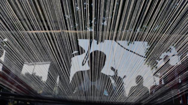 Strands of threads seen through a khadi handloom being woven by a member of the Mirgan tribe. (Arabinda Mahapatra/ht photo) Strands of threads seen through a khadi handloom being woven by a member of the Mirgan tribe. (Arabinda Mahapatra/ht photo)