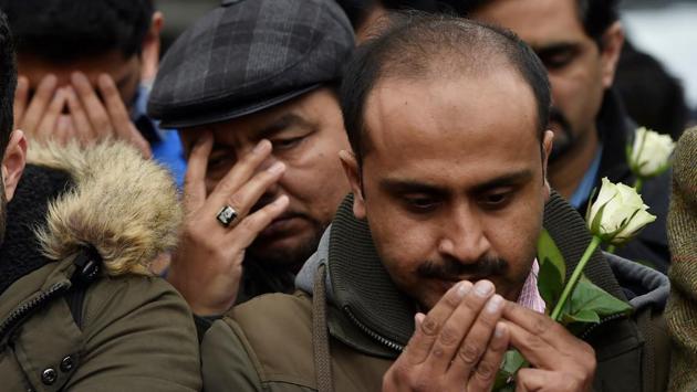 People pay their respects during the event. The other nine have been released. Officers have carried out searches at 17 addresses across England and Wales. (Hannah McKay/REUTERS) 