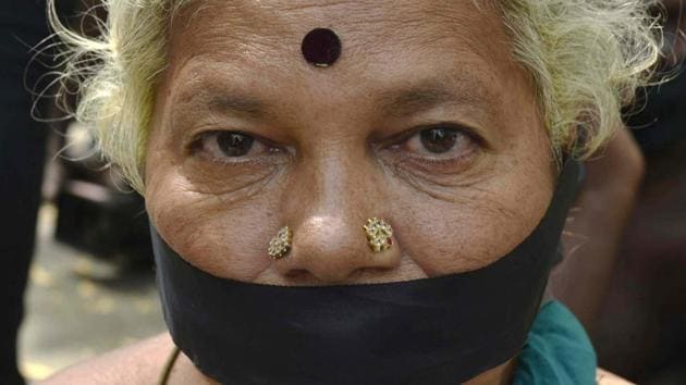 A lady covered her mouth with a black strip of cloth in protest. (Vipin Kumar/HT PHOTO)