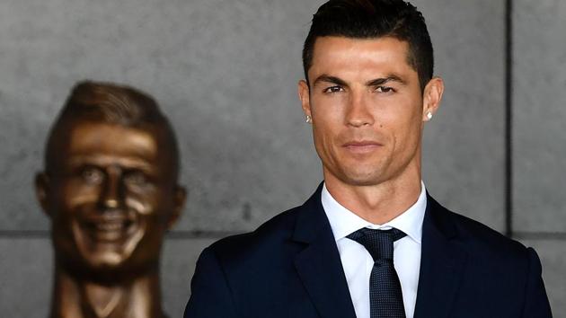 Cristiano Ronaldo stands past a bust uring a ceremony where Madeira's airport in Funchal was renamed after Ronaldo. (AFP) Cristiano Ronaldo stands past a bust uring a ceremony where Madeira's airport in Funchal was renamed after Ronaldo. (AFP)