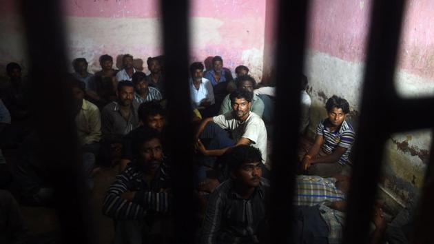Indian fisherman sit in a police lockup in Karachi on March 26 after they were arrested by Pakistan coast guards. (AFP Photo) Indian fisherman sit in a police lockup in Karachi on March 26 after they were arrested by Pakistan coast guards. (AFP Photo)