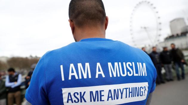 Some people dropped flowers into the River Thames, while others wore T-shirts reading: “I AM A MUSLIM. ASK ME ANYTHING”. (Stefan Wermuth/REUTERS) 