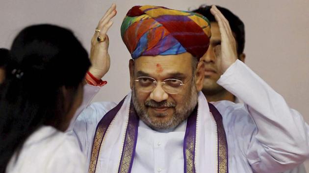 BJP president Amit Shah is presented a turban during a party workers' meeting in Ahmedabad on Thursday. (PTI) BJP president Amit Shah is presented a turban during a party workers' meeting in Ahmedabad on Thursday. (PTI)