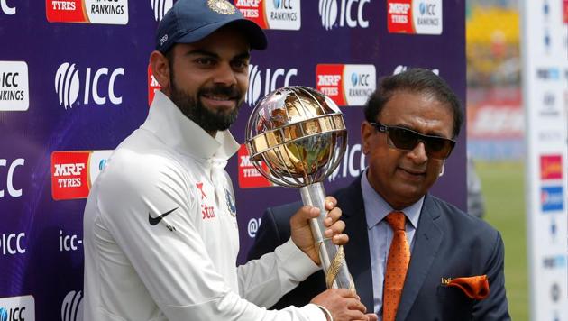 India skipper Virat Kohli receives the ICC Test Mace from cricket great Sunil Gavaskar (R) after India won the Test series against Australia.(REUTERS)
