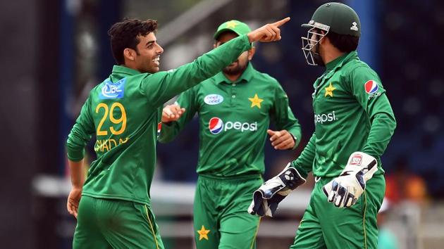 Pakistan's Shadab Khan (L) celebrates with teammates after dismissing West Indies' Kieron Pollard during the second of four-T20I-match between West Indies and Pakistan at the Queen’s Park Oval in Port of Spain.(AFP)