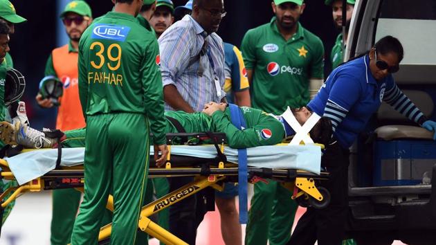 Pakistan's Ahmed Shehzad is taken off the field in an ambulance after he suffered a neck injury after colliding with West Indies' Chadwick Walton in Port of Spain.(AFP)