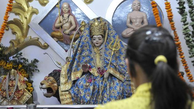 A devotee offering prayers to an idol of Durga mata in Ludhiana. (Gurminder Singh/HT)