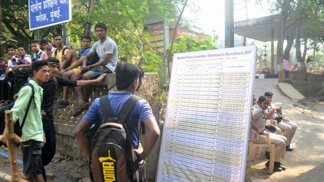 Few men check out the list at the Marol police camp in Andheri (West). (Prashant Waydande/HT PHOTO)