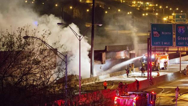 Smoke billows from a section of an overpass that collapsed from a large fire on Interstate 85 in Atlanta on March 30.(AP Photo) Smoke billows from a section of an overpass that collapsed from a large fire on Interstate 85 in Atlanta on March 30.(AP Photo)