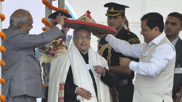 Assam chief minister Sarbananda Sonowal (right) and Governor Banwarilal Purohit (left) present a traditional hat Japi to President Pranab Mukherjee at the Namami Brahmaputra festival in Guwahati on Friday. (PTI) Assam chief minister Sarbananda Sonowal (right) and Governor Banwarilal Purohit (left) present a traditional hat Japi to President Pranab Mukherjee at the Namami Brahmaputra festival in Guwahati on Friday. (PTI)