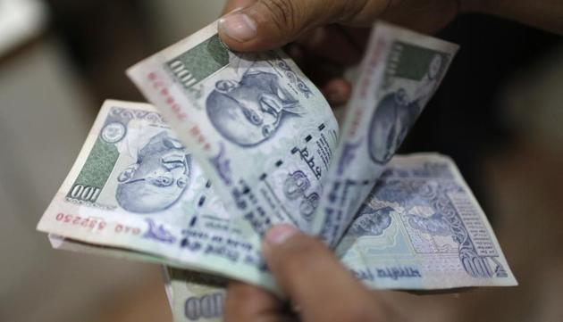 An man counts money inside a private money exchange office in New Delhi.(REUTERS File)