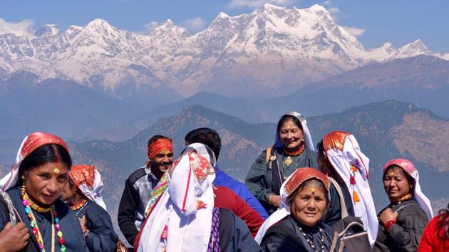 Women from the Bhutia community in traditional attire from the surrounding Chamoli district visit the Kartik Swami Temple on a festive occasion, seen here in the backdrop of higher Himalayan ranges including Chaukhamba, right, and the Kedarnath ranges, left. (Gurinder Osan/HT Photo)