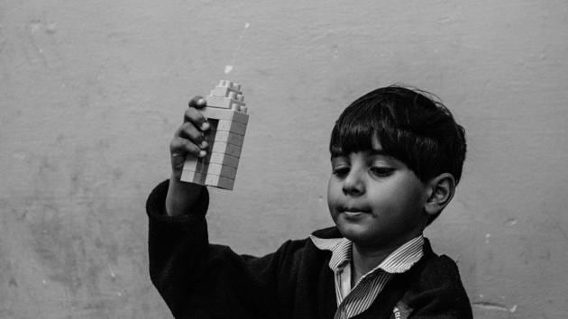 Aryan shows compulsive behaviour traits which are common with autistic children. Here he using single colored blocks to make what his teacher assumed was India Gate but he kept repeating the term "tower castle." (Vageesh Lall/ HT Photo)