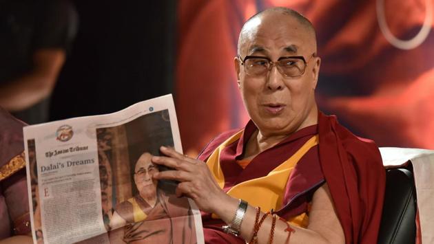 Tibetan spiritual leader Dalai Lama reads a newspaper at an event in Guwahati on April 1, 2017. Beijing has said it opposes plans in April for the Tibetan exiled leader the Dalai Lama to visit Arunachal Pradesh. (AFP)