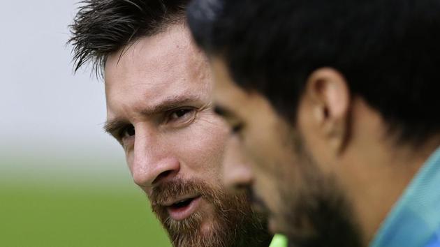 FC Barcelona's Lionel Messi (background) attends a training session at the Sports Center FC Barcelona Joan Gamper in Sant Joan Despi, Spain on Saturday. (AP) FC Barcelona's Lionel Messi (background) attends a training session at the Sports Center FC Barcelona Joan Gamper in Sant Joan Despi, Spain on Saturday. (AP)