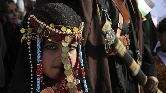 A bedouin girl wears traditional dress attend a rally marking the 41st anniversary of Land Day, in Deir el-Balah, Central Gaza Strip, Friday, March 31, 2017.Land Day commemorates riots on March 30, 1976, when many were killed during a protest by Israeli Arabs whose property was annexed in northern Israel to expand Jewish communities. (Adel Hana / AP)