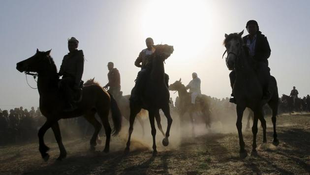Bedouin youths ride their horses during a rally marking the 41st anniversary of Land Day, in Deir el-Balah, Central Gaza Strip. (Adel Hana / AP)
