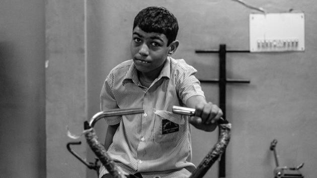 Rahul makes an effort on an exercise cycle as part of his daily routine at an NGO centre in New Delhi. Autism is one of the most common neurological disorders that affects the way a child reacts to people and his immediate environment, with one out of five hundred children in India diagnosed with this medical condition. (Vageesh Lall/ HT Photo)