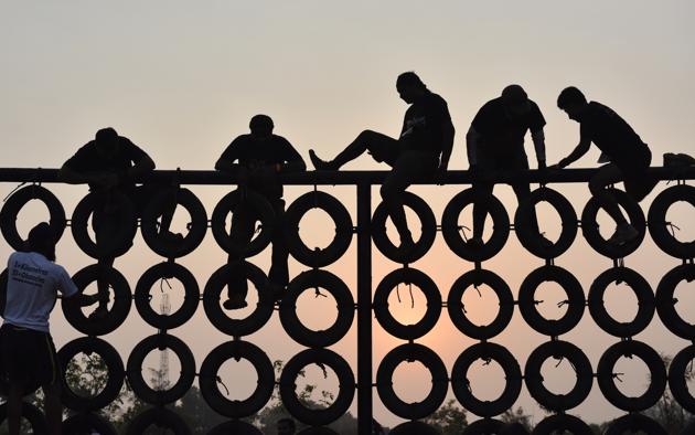 Participants during an obstacle race at Yelahanka in Bengaluru, India. More than 2000 people took part in the 5km long race with more than 20 obstacles. (Arijit Sen/HT Photo)